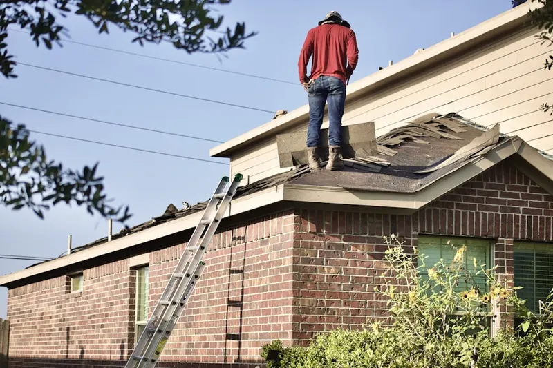Professional roofer working on a residential roof in Maryland Line